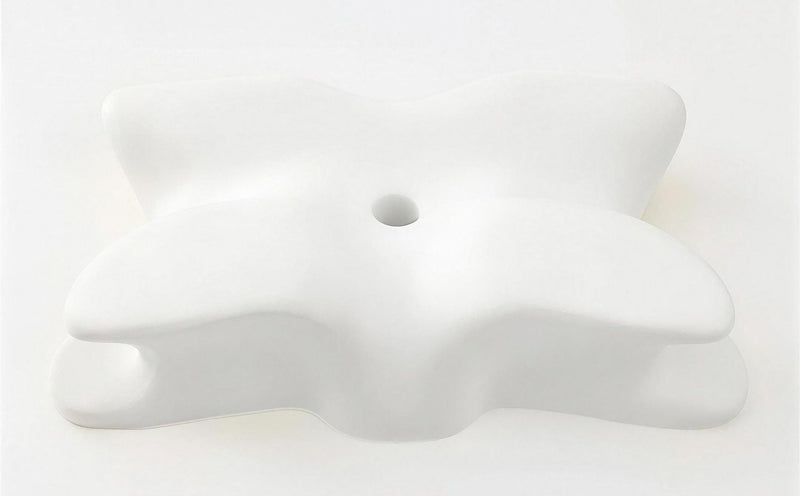 The bare memory foam core of the SleepSculpt pillow with its cover removed